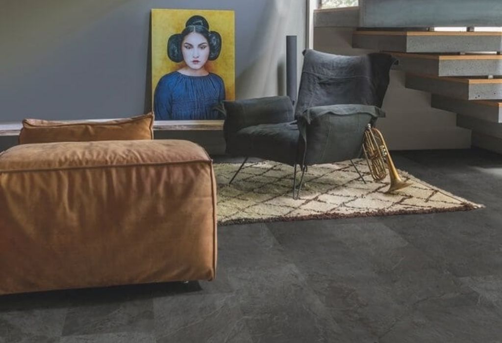 Kamienna podłoga z paneli winylowych, pomarańczowa sofa, obraz
